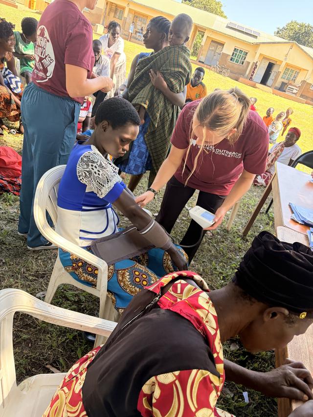 Examining a patient at a community outreach