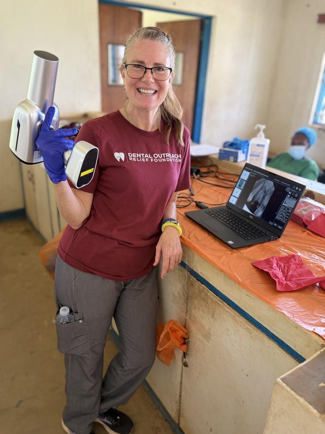 A volunteer with a portable dental X-ray unit